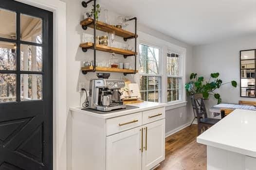 bar featuring hardwood / wood-style flooring and white cabinetry