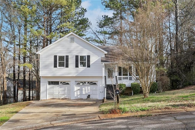 tri-level home with a garage, driveway, and a porch