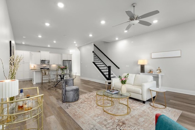 living room featuring ceiling fan and light wood-type flooring