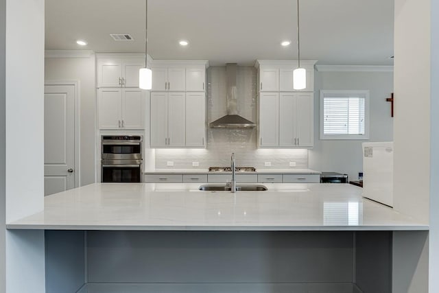 1459 Bennett Creek Ovlk, Suwanee, GA 30024 - kitchen featuring wall chimney exhaust hood, appliances with stainless steel finishes, ornamental molding, backsplash, and white cabinets