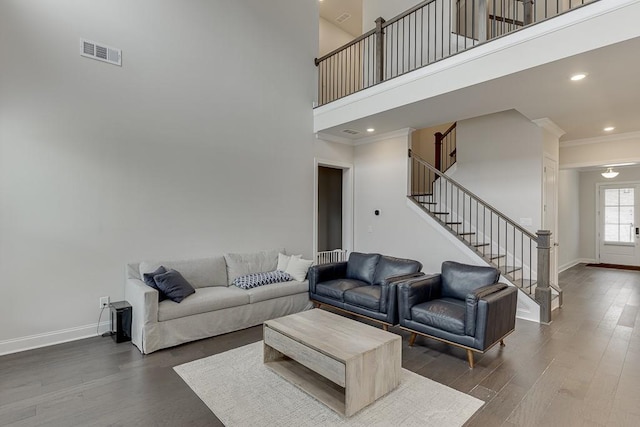 1459 Bennett Creek Ovlk, Suwanee, GA 30024 - living room with stairs, wood finished floors, a towering ceiling, crown molding, and recessed lighting