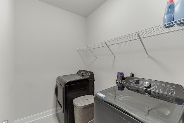 1459 Bennett Creek Ovlk, Suwanee, GA 30024 - laundry room featuring washing machine and clothes dryer and tile patterned flooring