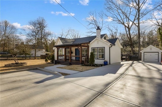 view of front of property with a porch, a garage, an outdoor structure, fence, and a chimney