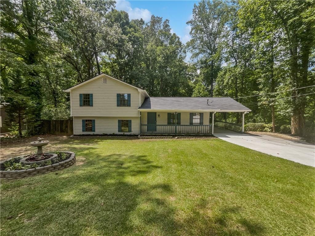 tri-level home with a front lawn