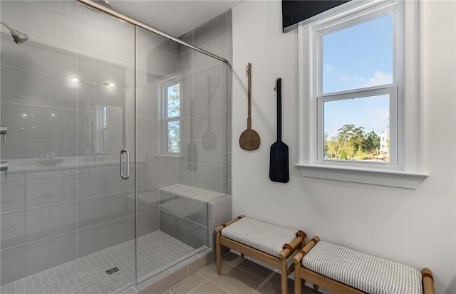 full bath with a stall shower and tile patterned floors