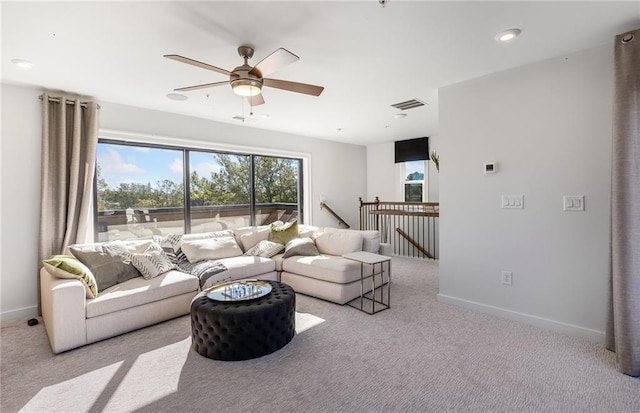 carpeted living room featuring visible vents, ceiling fan, and baseboards