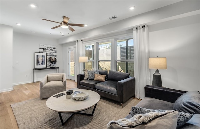 living area featuring recessed lighting, visible vents, light wood-style floors, a ceiling fan, and baseboards