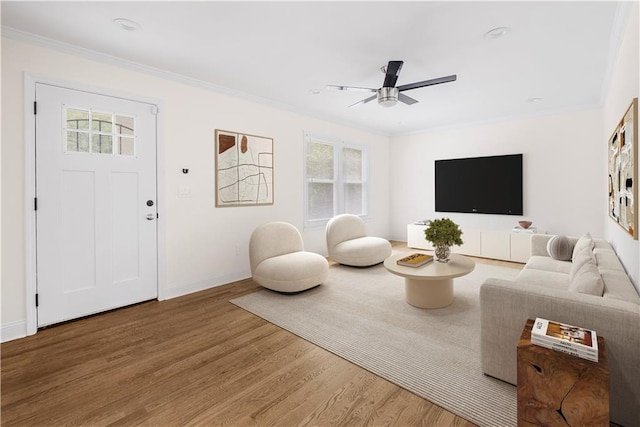 living room featuring ornamental molding, ceiling fan, and hardwood / wood-style floors