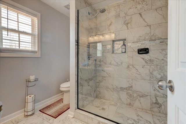 bathroom featuring toilet, visible vents, baseboards, and a marble finish shower