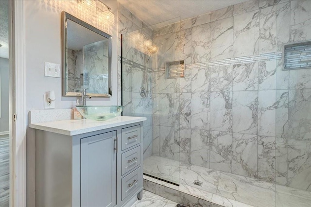 bathroom featuring vanity, marble finish floor, and a marble finish shower