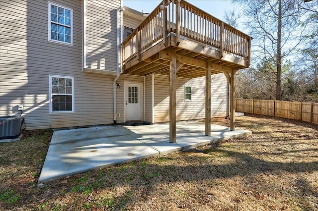 rear view of house featuring cooling unit, a patio area, fence, and a wooden deck