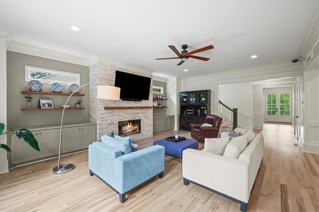 4048 Navajo Trl, Brookhaven, GA 30319 - living area featuring a fireplace, ornamental molding, light wood finished floors, stairway, and a ceiling fan