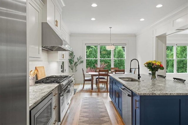 4048 Navajo Trl, Brookhaven, GA 30319 - kitchen featuring a sink, blue cabinetry, stainless steel appliances, healthy amount of natural light, and recessed lighting