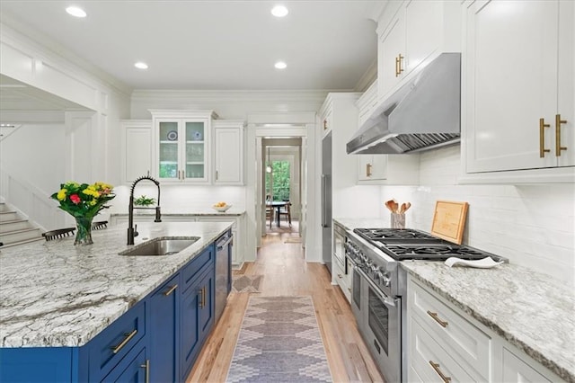 4048 Navajo Trl, Brookhaven, GA 30319 - kitchen featuring under cabinet range hood, a sink, blue cabinetry, white cabinets, and recessed lighting