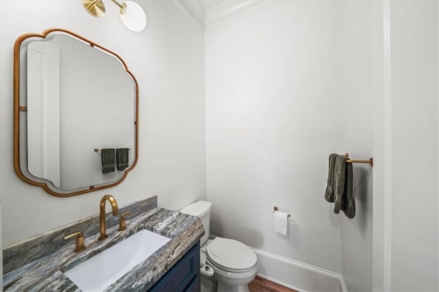 4048 Navajo Trl, Brookhaven, GA 30319 - bathroom with toilet, vanity, ornamental molding, baseboards, and wood finished floors