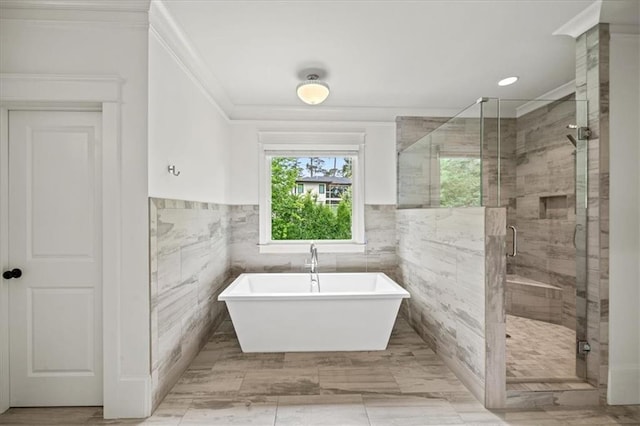 4048 Navajo Trl, Brookhaven, GA 30319 - full bathroom featuring ornamental molding, tile walls, a soaking tub, a shower stall, and a wainscoted wall