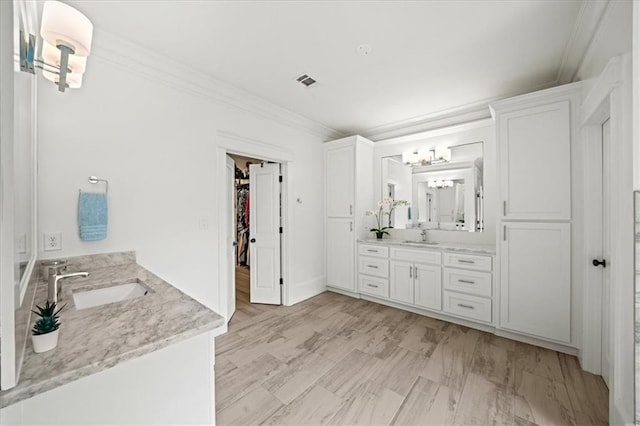 4048 Navajo Trl, Brookhaven, GA 30319 - bathroom with two vanities, ornamental molding, a walk in closet, and a chandelier