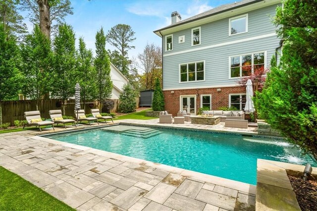 4048 Navajo Trl, Brookhaven, GA 30319 - back of house featuring outdoor lounge area, a patio area, a chimney, brick siding, and a fenced backyard
