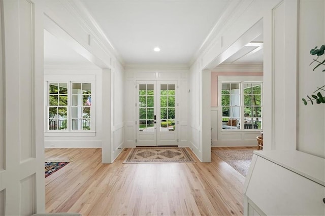 4048 Navajo Trl, Brookhaven, GA 30319 - entryway with crown molding, a decorative wall, light wood-style flooring, and french doors