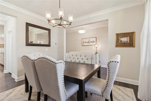 dining space with dark wood-type flooring, crown molding, and baseboards