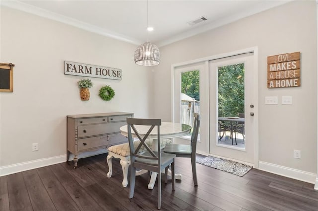 dining space with dark wood finished floors, visible vents, and baseboards