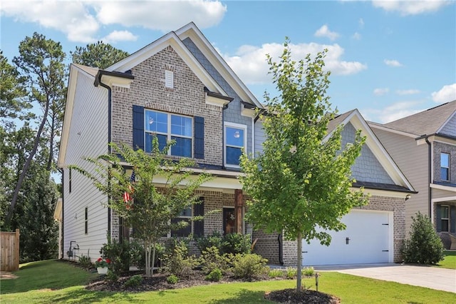 craftsman house featuring driveway, a garage, a front lawn, and brick siding