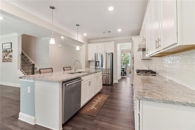 kitchen featuring backsplash, appliances with stainless steel finishes, white cabinetry, a sink, and under cabinet range hood