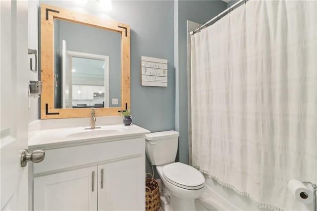 bathroom featuring toilet, vanity, and shower / tub combo with curtain