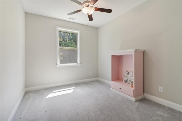 unfurnished bedroom with a ceiling fan, carpet, visible vents, and baseboards