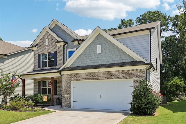 craftsman inspired home featuring an attached garage, driveway, a front lawn, and brick siding