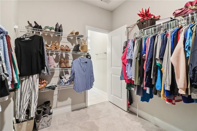 walk in closet with carpet floors