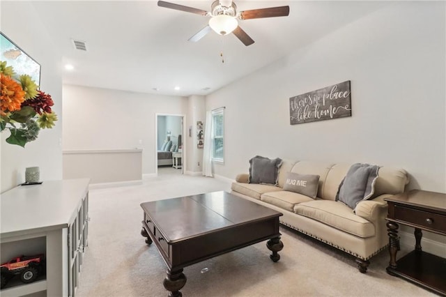 living area with ceiling fan, recessed lighting, light carpet, visible vents, and baseboards