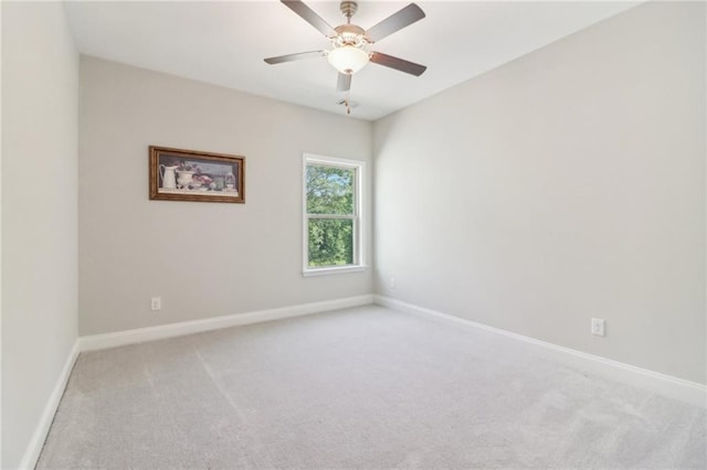 unfurnished room featuring light carpet, ceiling fan, and baseboards