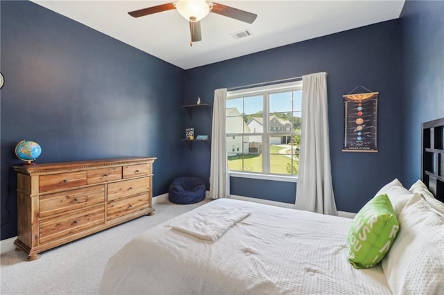 carpeted bedroom featuring visible vents, ceiling fan, and baseboards