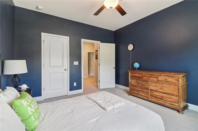 carpeted bedroom featuring a ceiling fan and baseboards