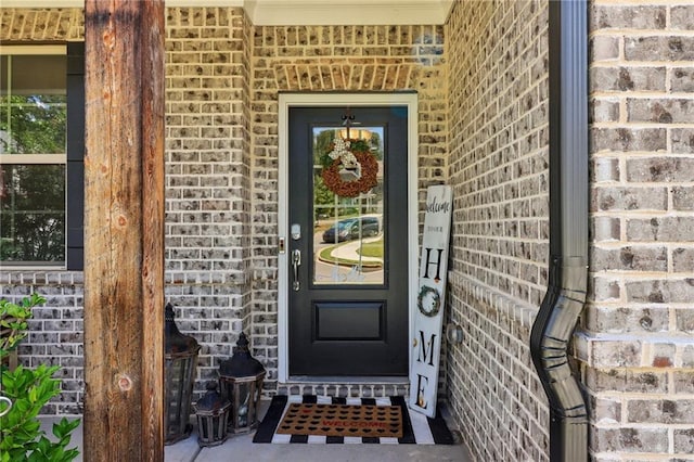 property entrance featuring brick siding