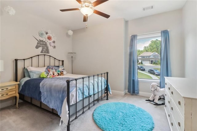 bedroom featuring ceiling fan, baseboards, visible vents, and light colored carpet