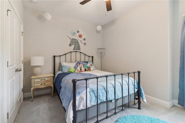 carpeted bedroom with a ceiling fan and baseboards