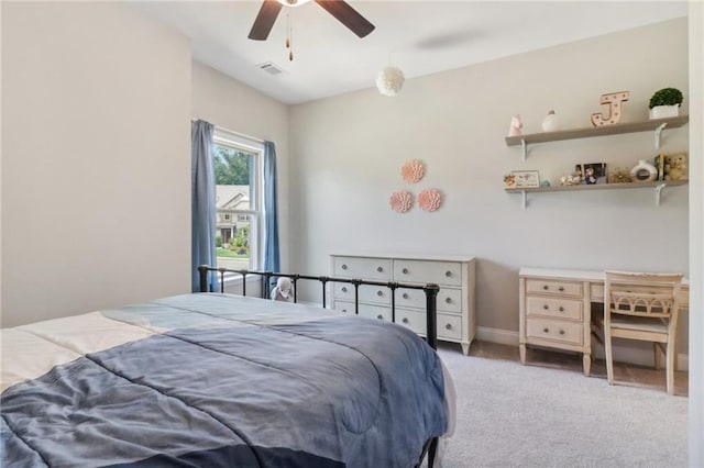 carpeted bedroom with visible vents and a ceiling fan