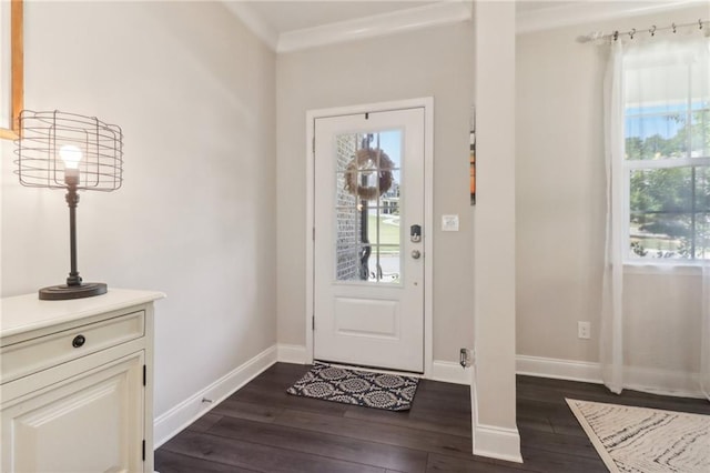 entryway with crown molding, dark wood finished floors, and baseboards