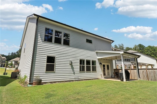 back of house featuring a yard, fence, and a patio