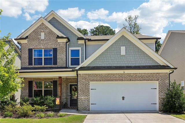 craftsman-style house with a garage, concrete driveway, and brick siding