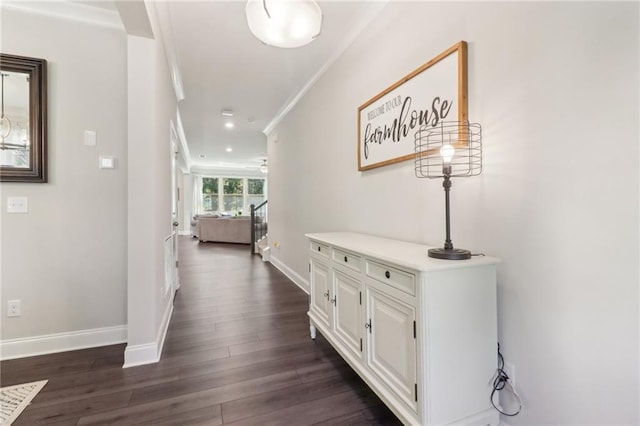 corridor with dark wood-style floors, recessed lighting, stairway, ornamental molding, and baseboards