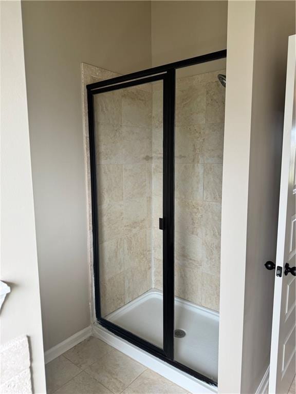 3897 Valley Bluff Ln, Snellville, GA 30039 - full bath with a stall shower, tile patterned floors, and baseboards
