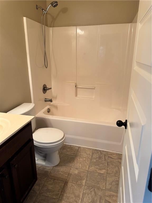 3897 Valley Bluff Ln, Snellville, GA 30039 - full bath featuring vanity, shower / bath combination, toilet, and stone finish flooring