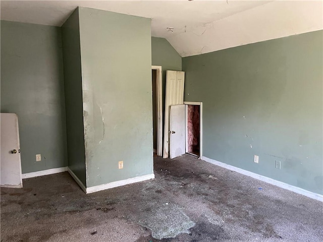 spare room with vaulted ceiling