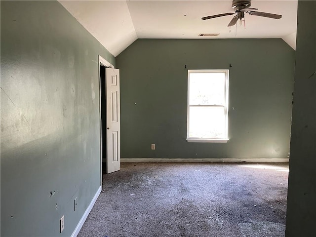 carpeted empty room featuring ceiling fan and lofted ceiling