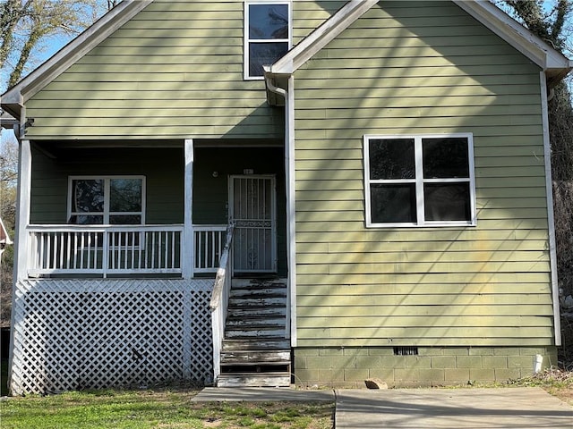 view of side of property with a porch