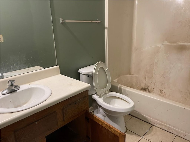 bathroom with tile patterned flooring, vanity, and toilet