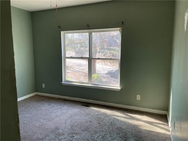 unfurnished room featuring plenty of natural light